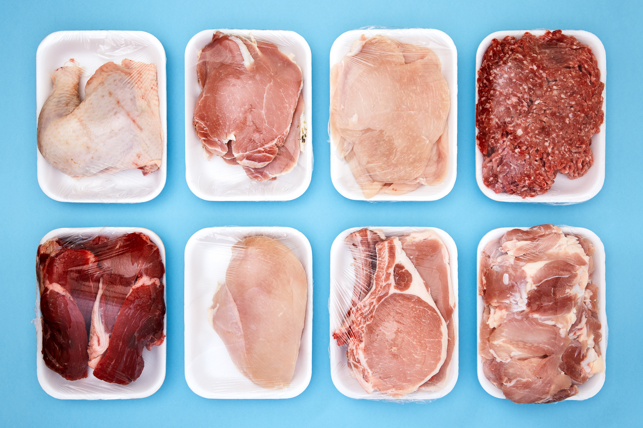 Variety of raw meat in foam packaging trays